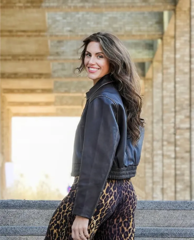 Portrait of Ava, a warm and confident mid-40s facilitator.