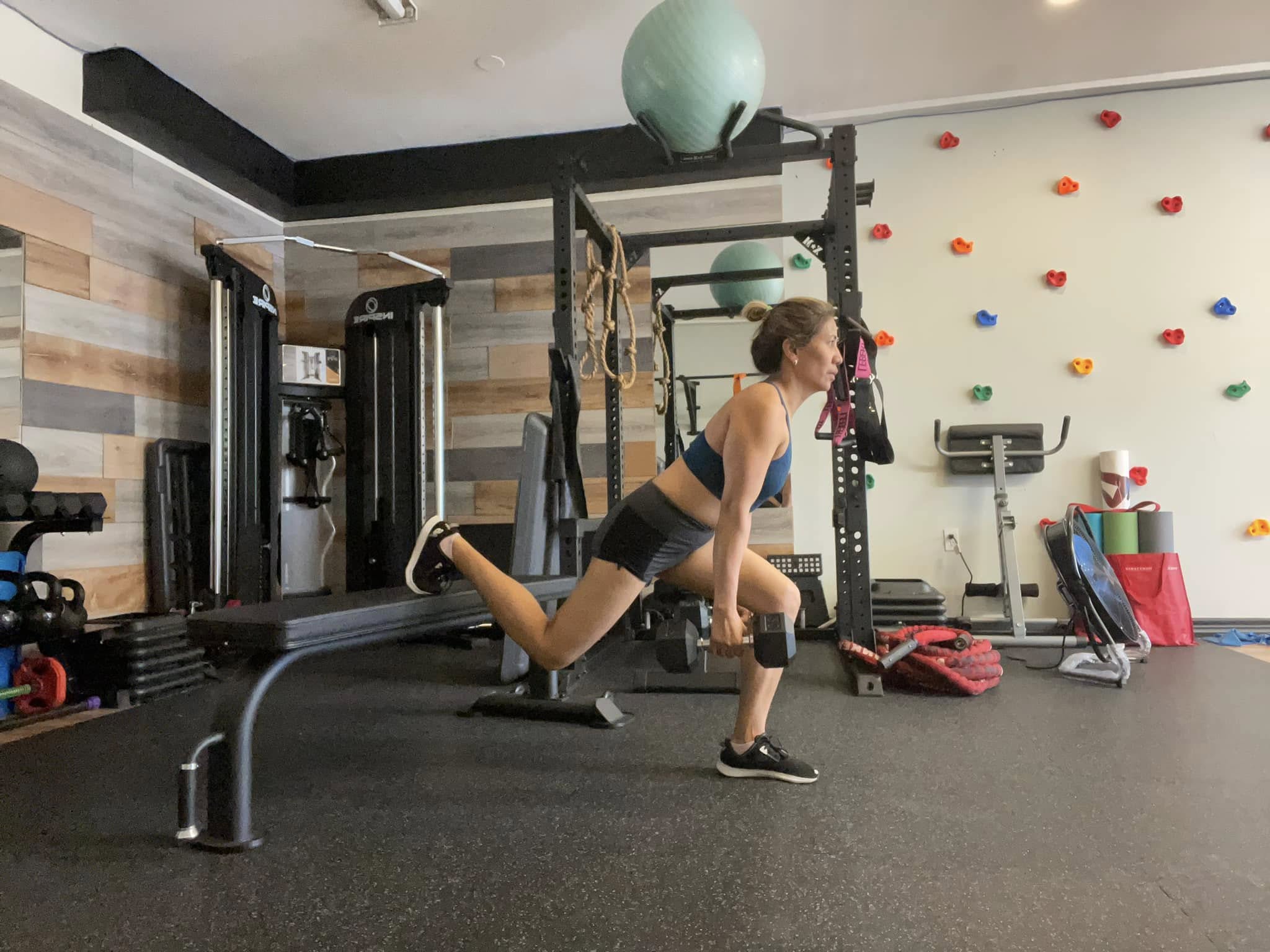 man in orange tank top and black shorts doing exercise