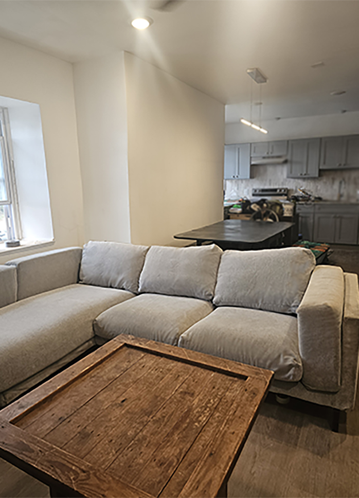 Photo of Living Room sofa with chaise lunge and wooden offee table.