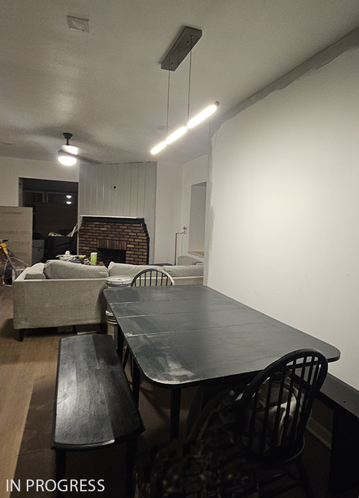 Photo of navy blue dining table with chaitrs and benches.