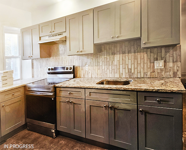 Photo of kitchen counter with oven and faucet.