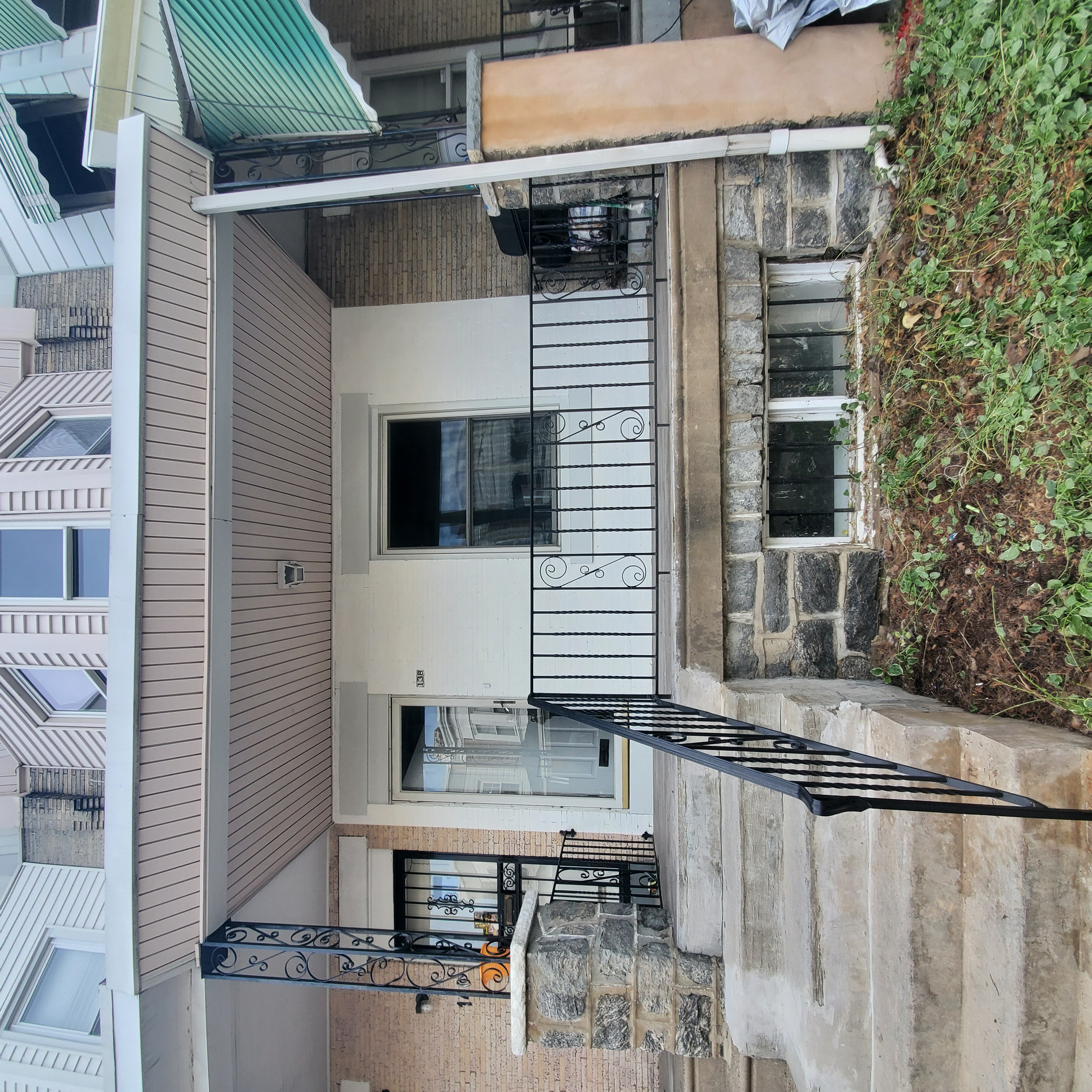 Exterior of a peach and cream colored rowhome.