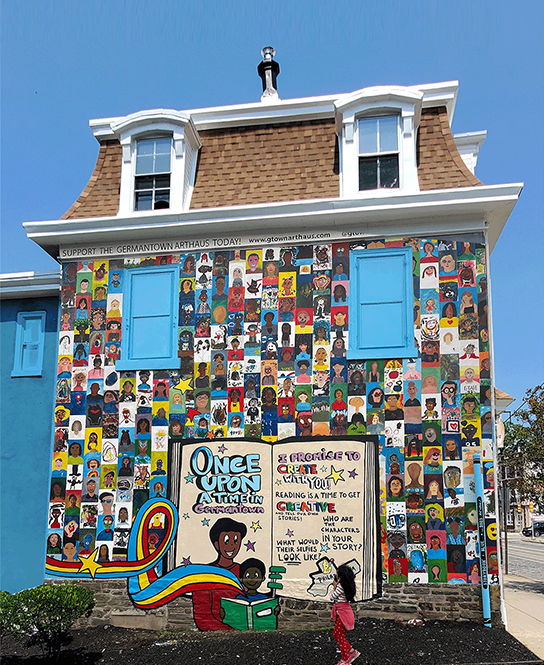 Exterior of a 3-story home with a colorful mural n the side.