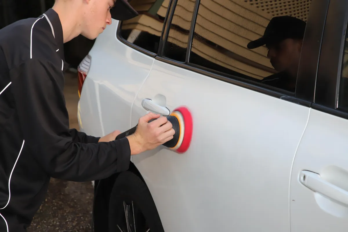 Millzy polishing a car body
