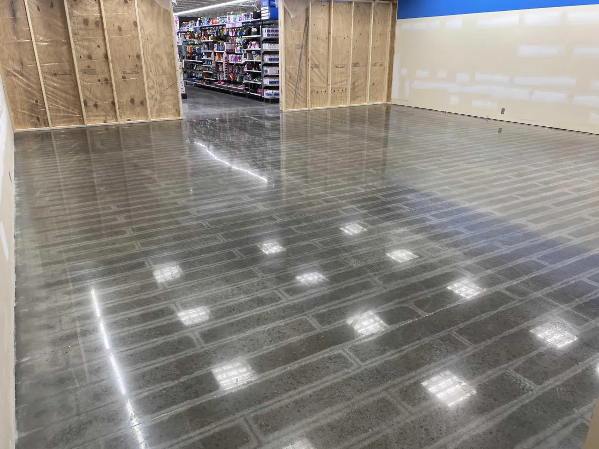 Boutique retail store featuring a custom-patterned, aqua and white epoxy floor, modern displays, and natural lighting. The unique floor design adds personality and style, illustrating the creative possibilities of custom epoxy solutions.