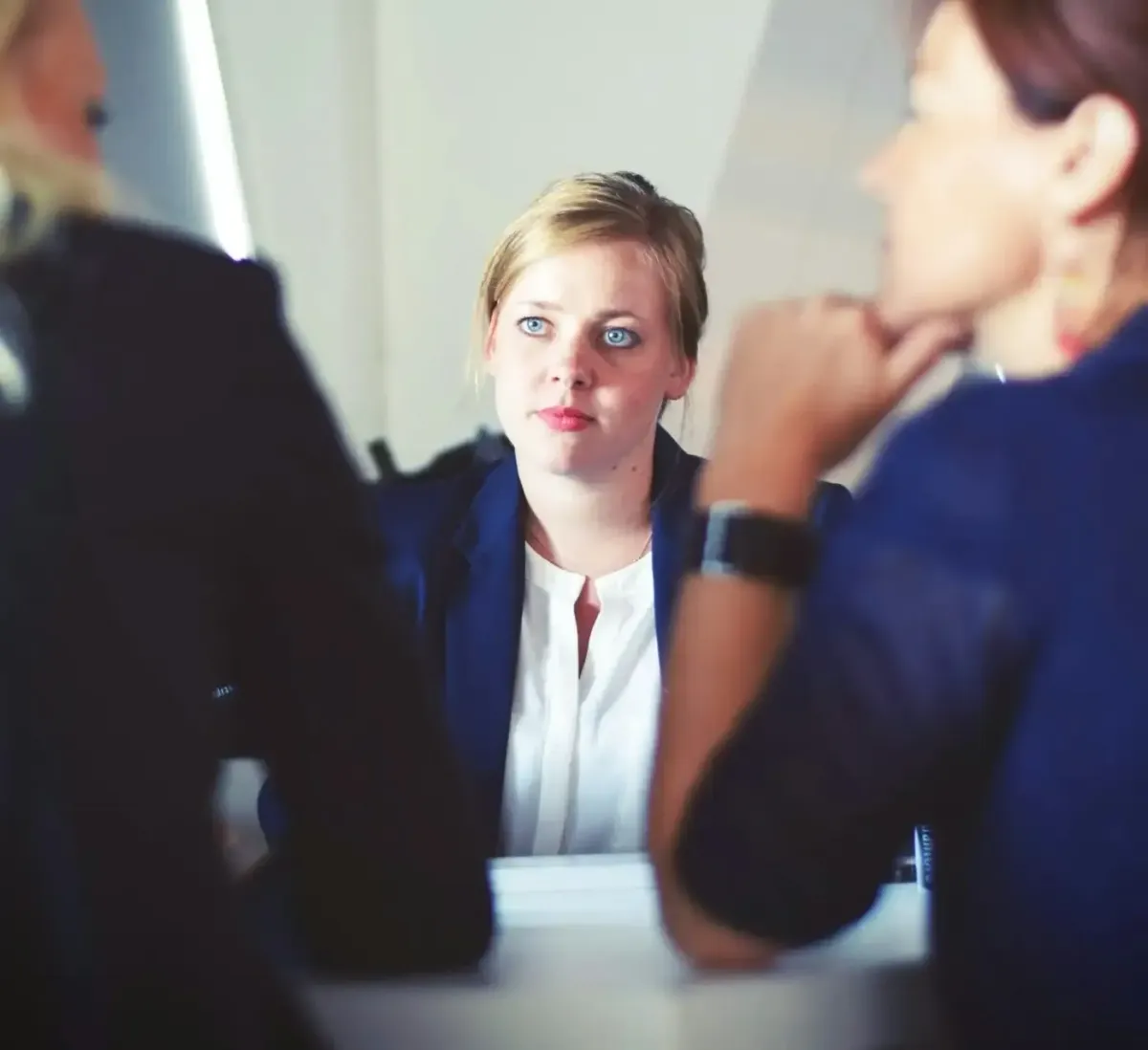 A person being interviewed by 2 people