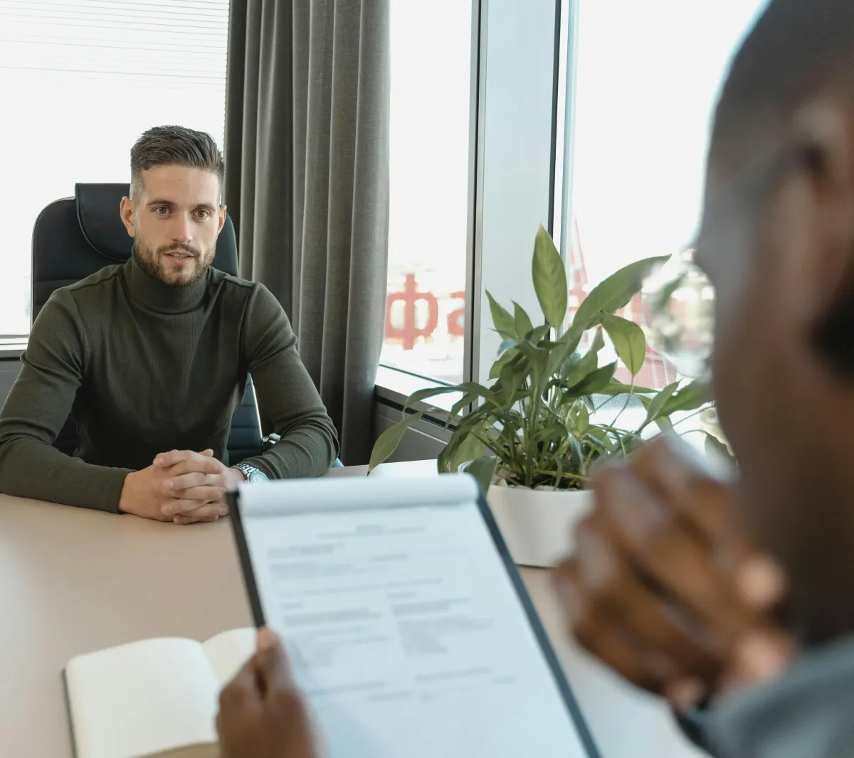A person answering questions and leading the interview