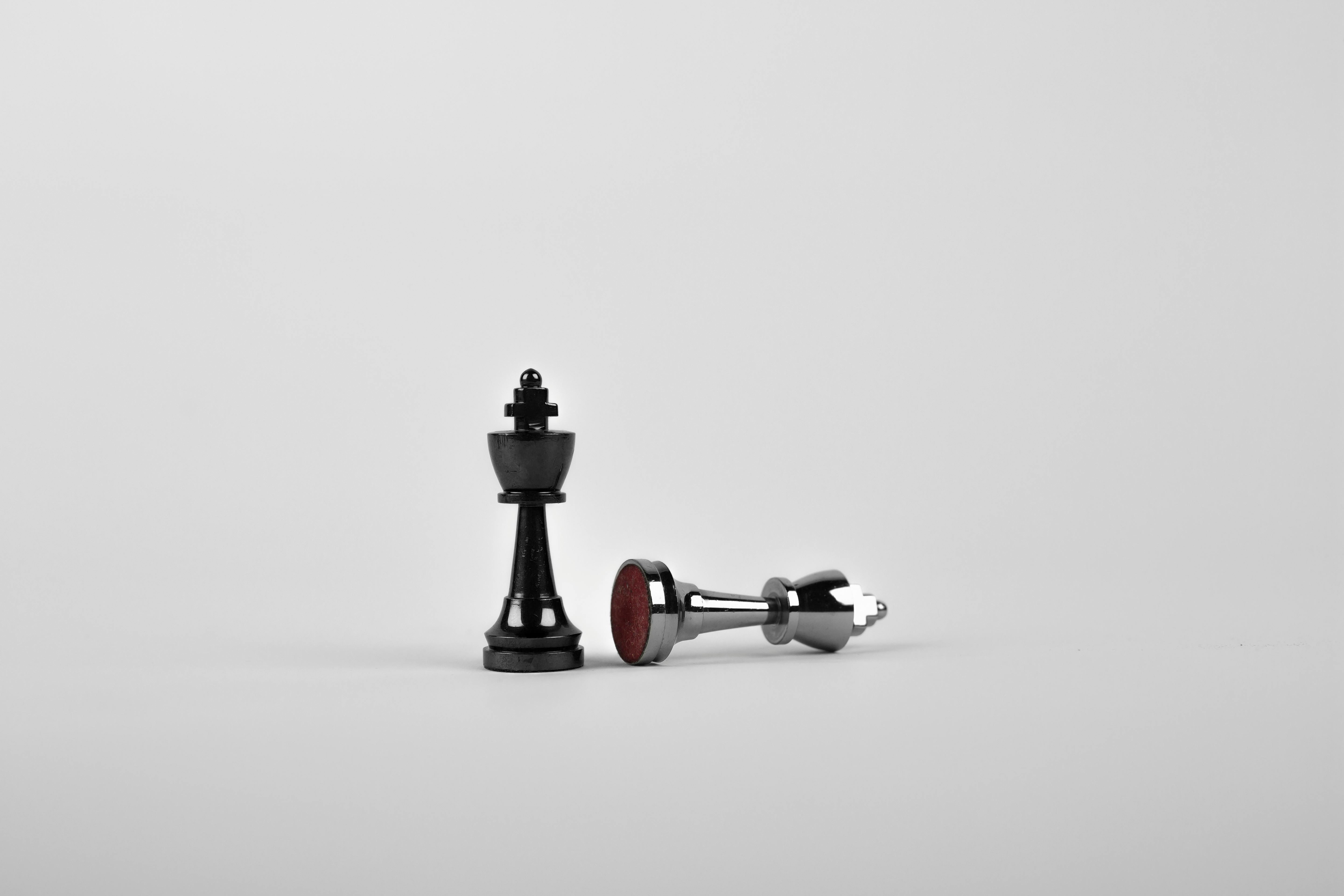 Image of chess pieces of one king standing and one fallen king, image by sebastian from pexels
