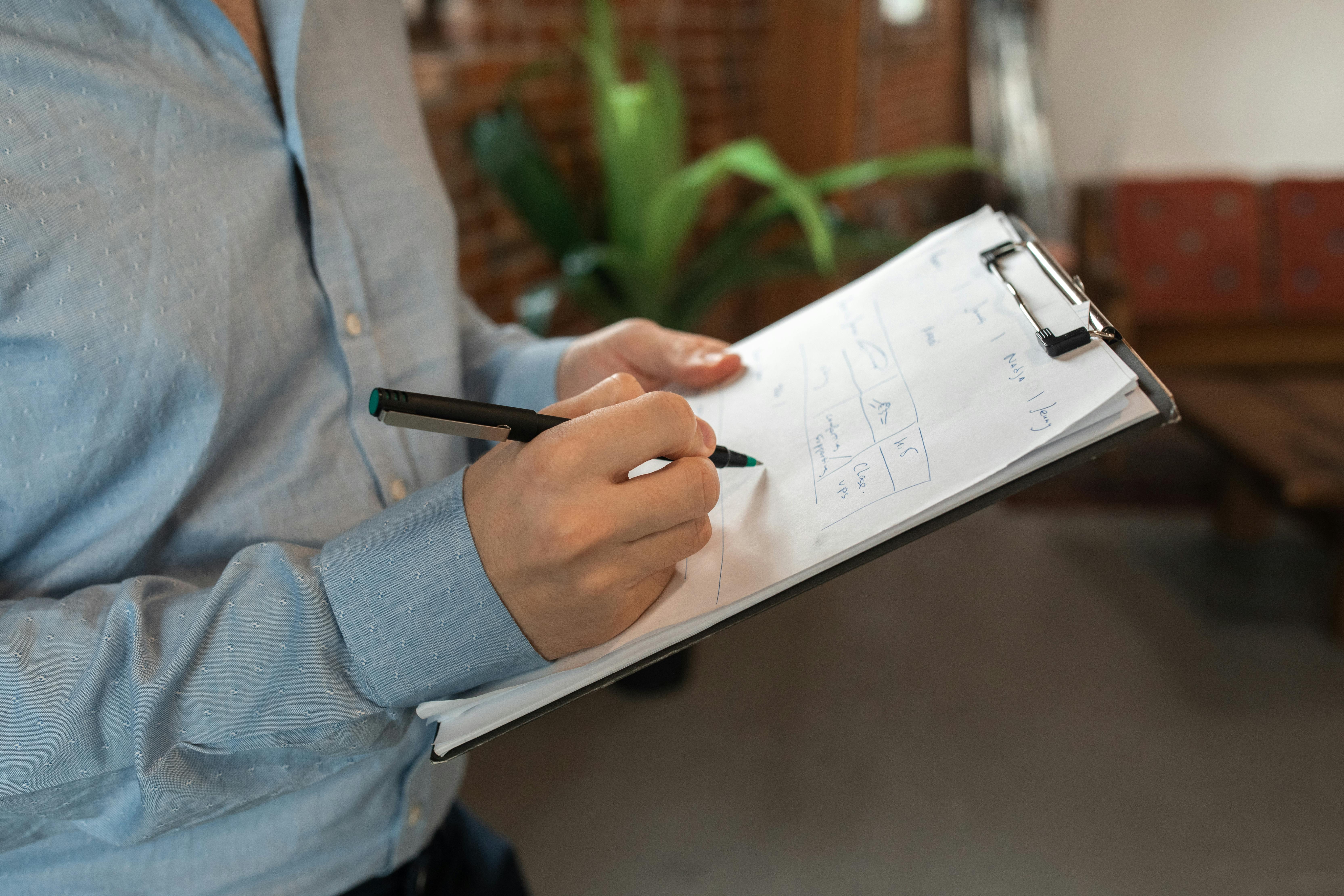 Image of a professional going through check list Photo by RDNE Stock project: https://www.pexels.com/photo/person-holding-a-black-pen-writing-on-a-white-paper-5756660/