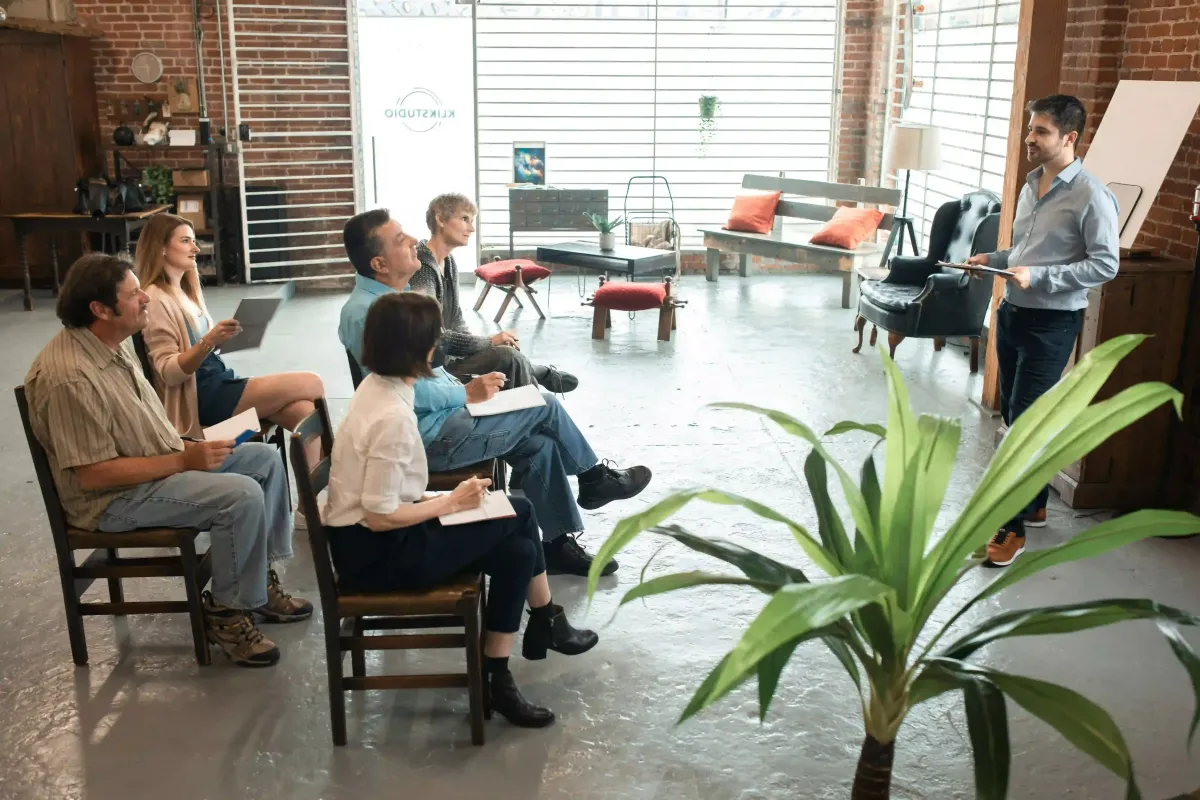Photo by RDNE Stock project: https://www.pexels.com/photo/adult-people-in-a-room-sitting-on-brown-wooden-chairs-5756664/