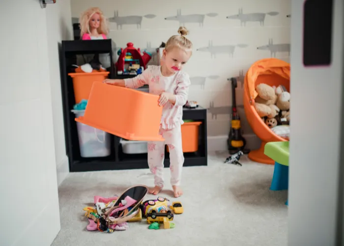 child spilling toys from basket