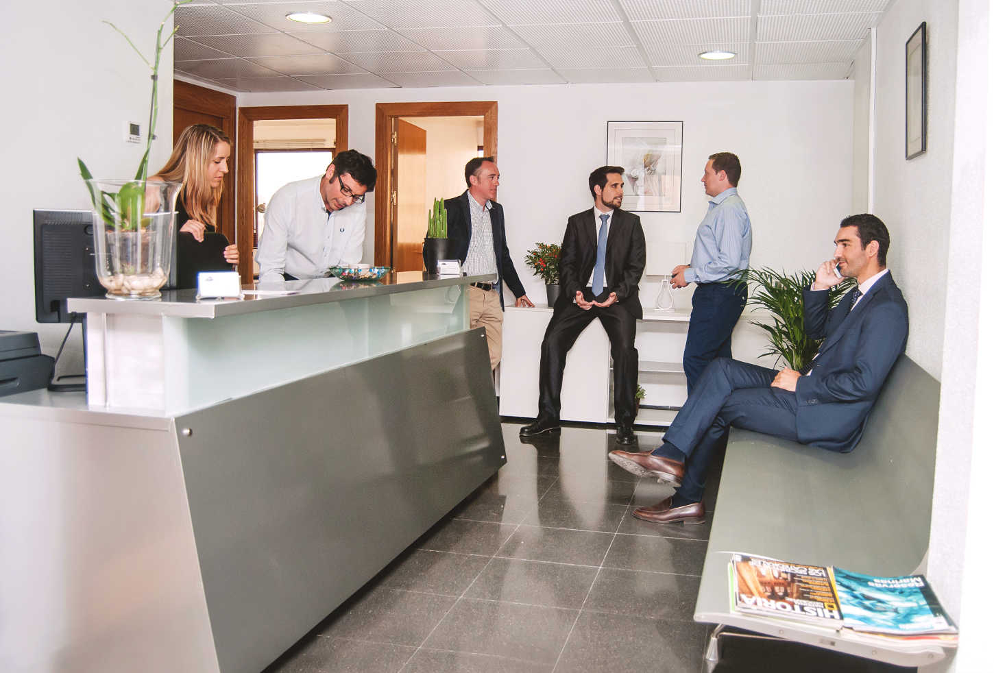 A diverse legal team in a glass-walled boardroom, celebrating a successful telecom case outcome. Documents and digital charts are visible, with city skyline in the background. The mood is triumphant and collaborative, with a mix of genders and ethnicities.