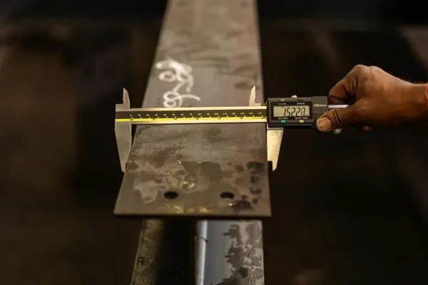 Inspector measuring product with calipers