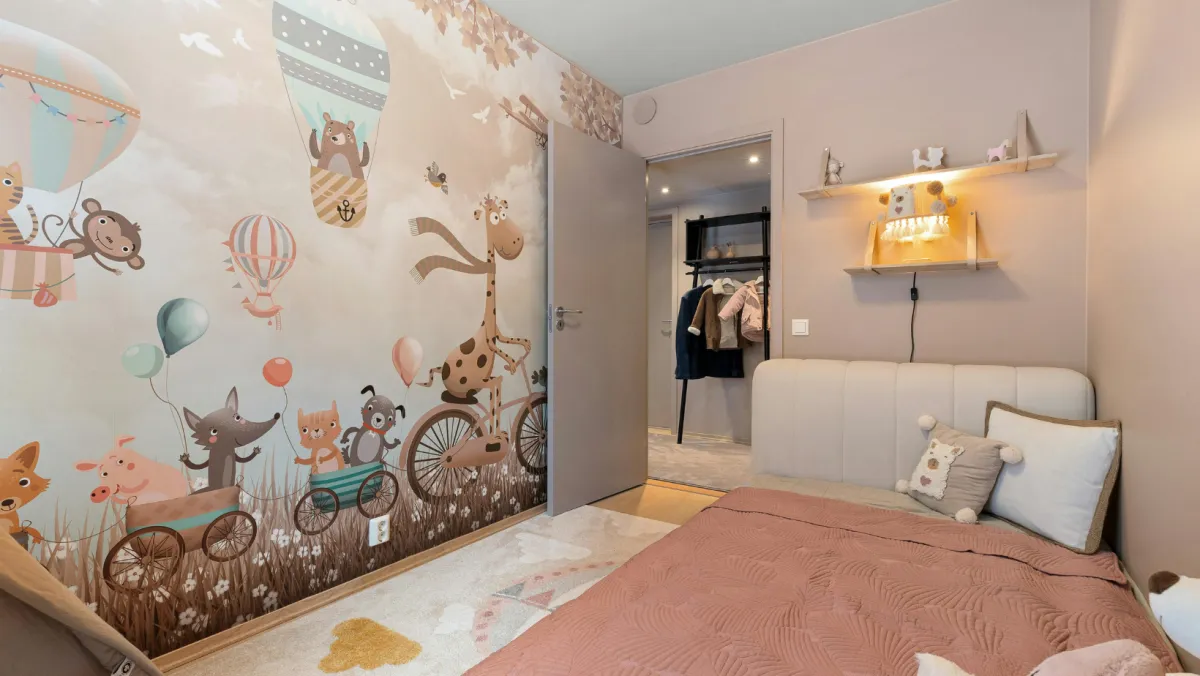 Picture of a child's room with wallpaper.
