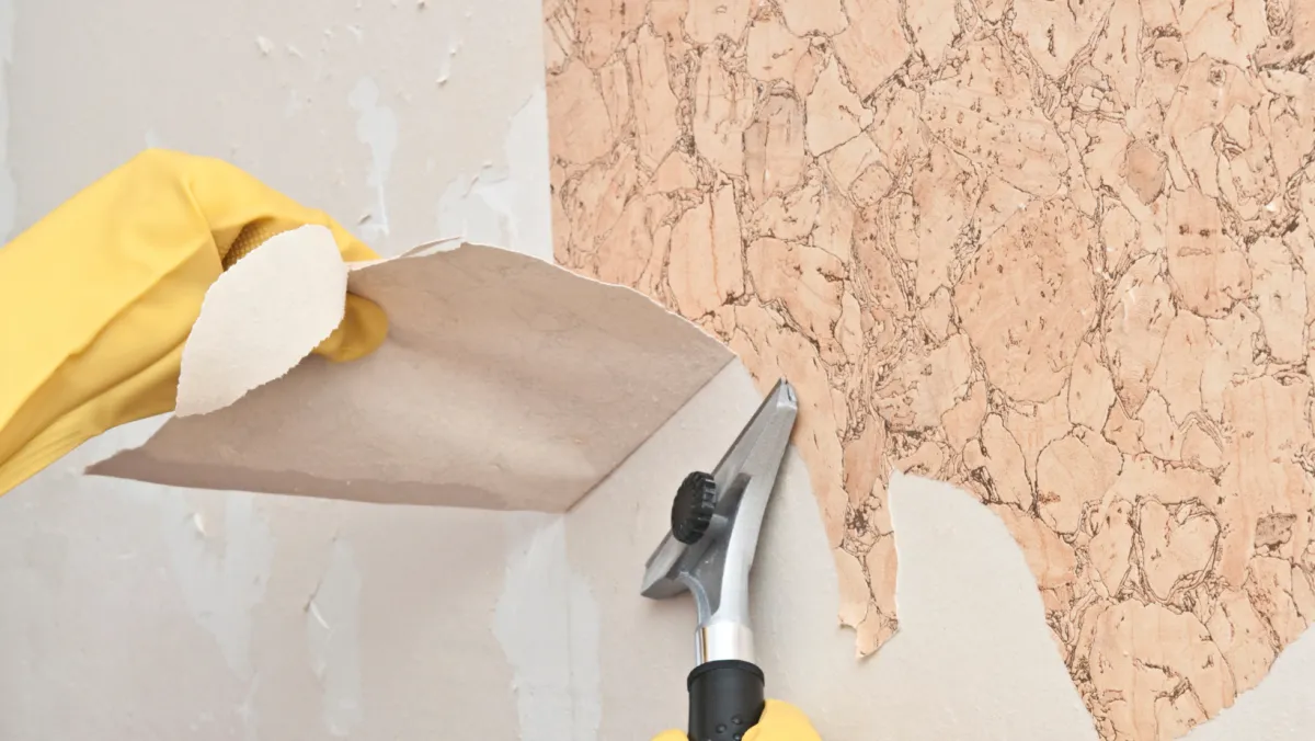 Photo of wallpaper being removed.