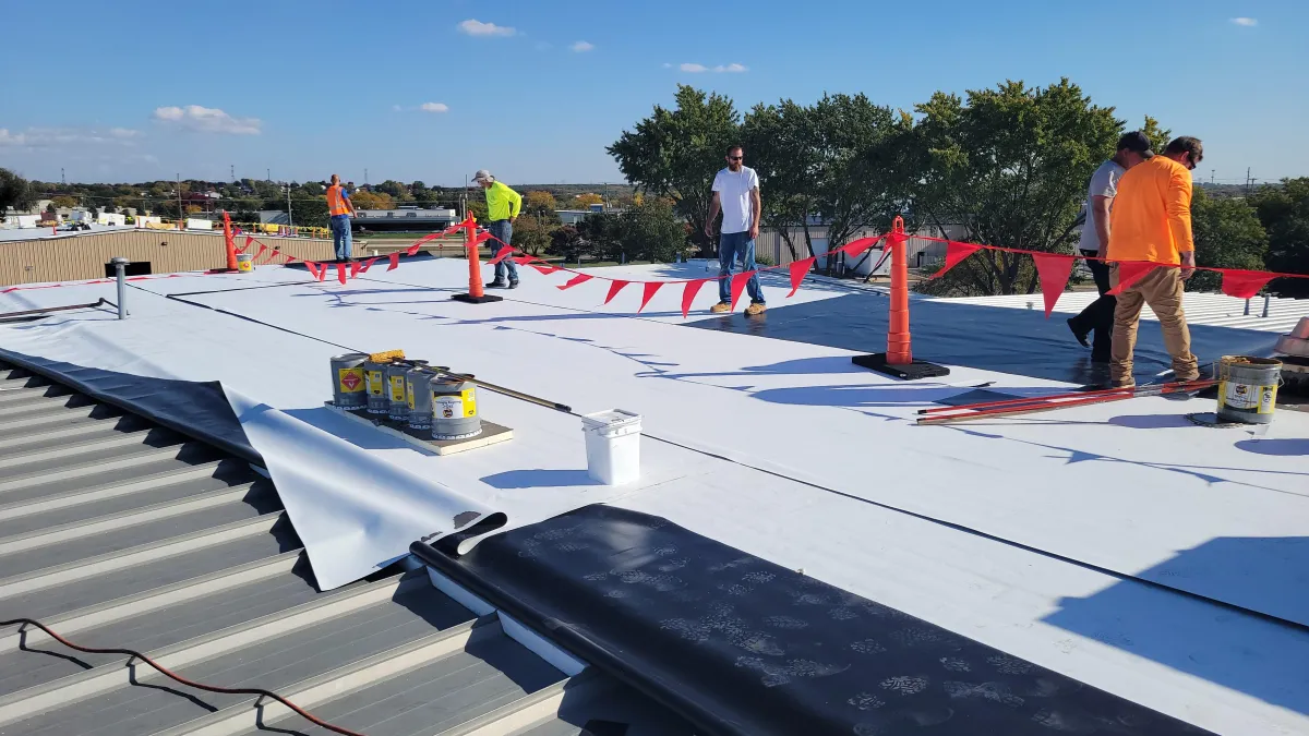 Flat commercial roof with TPO/EPDM membrane installed by professional roofing crew