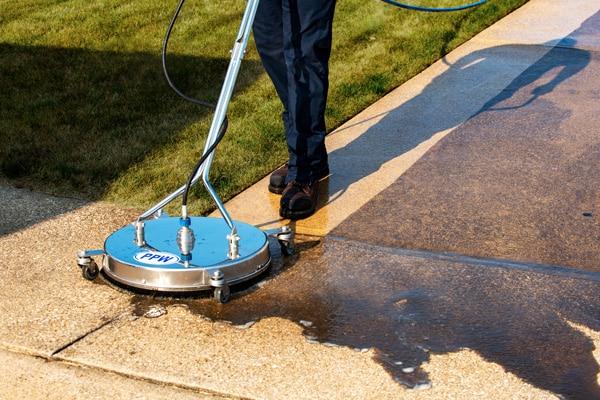 Professional power washing and scrubbing removing dirt and grime from exterior surfaces