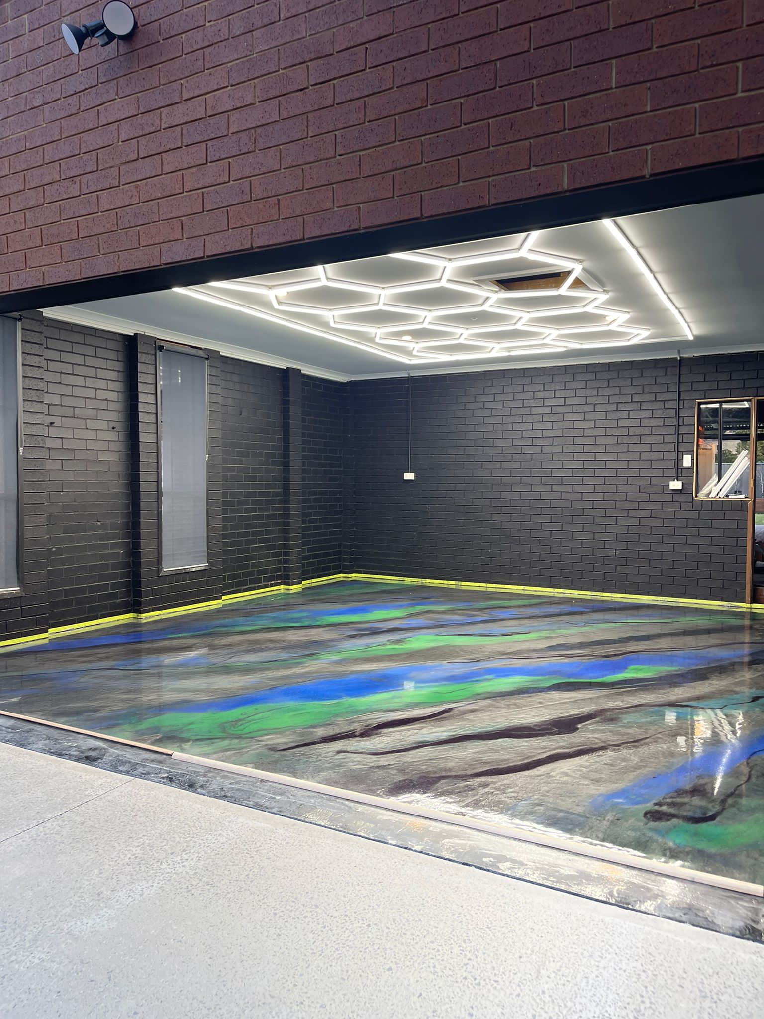 Blue and green metallic floor in home garage