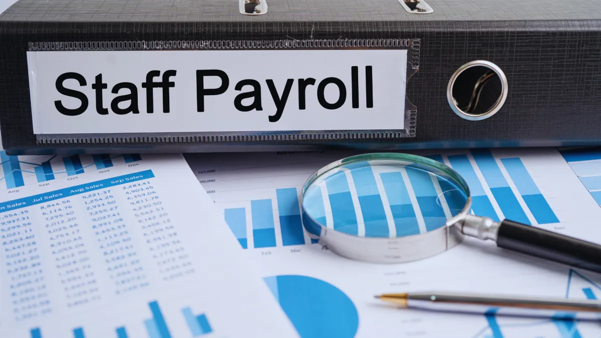 Payroll support services pay stub on a desk