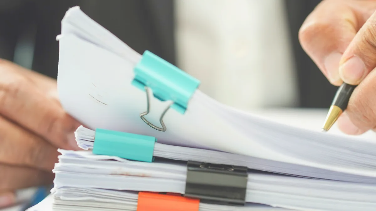 Accounts payable and receivable invoices on a desk