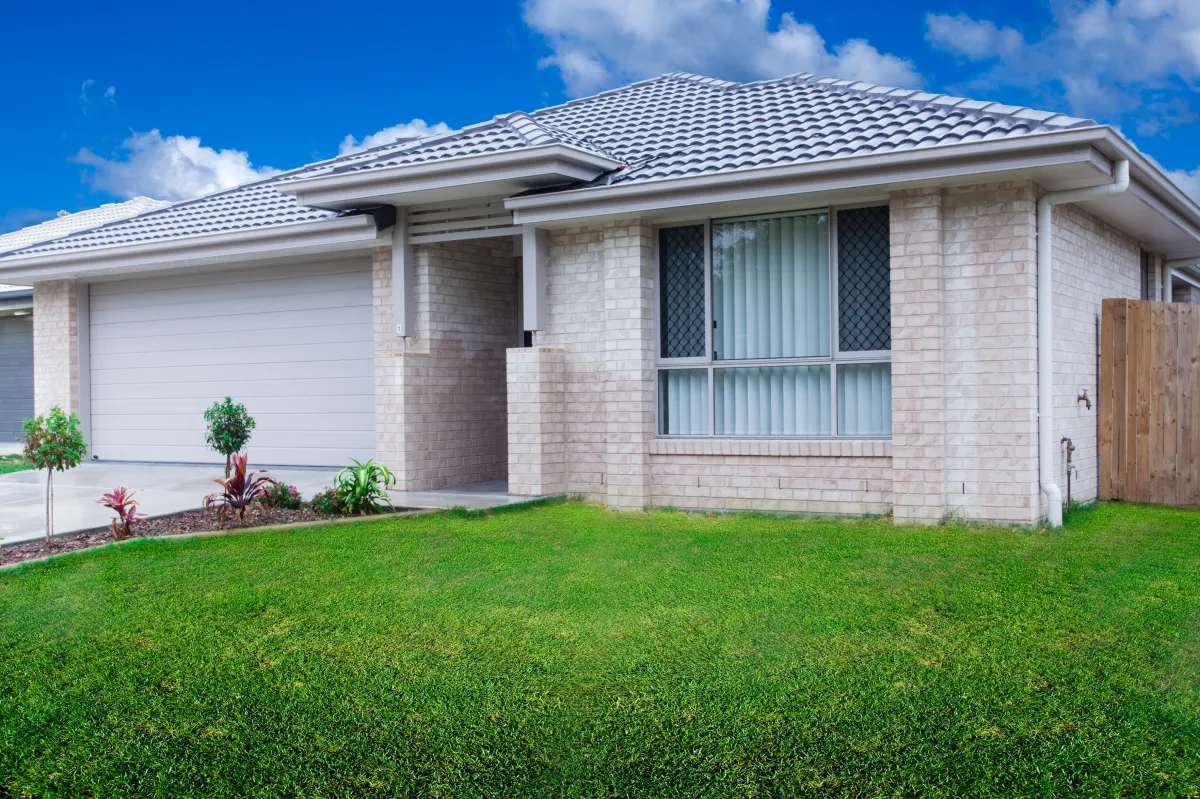 a modern house with a large front yard