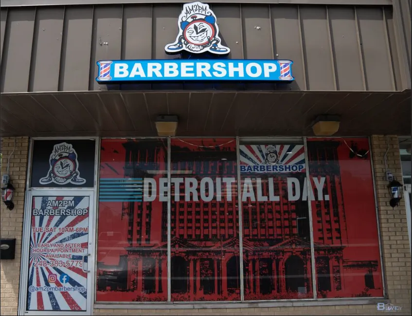 gray scale photo of man inside barber shop