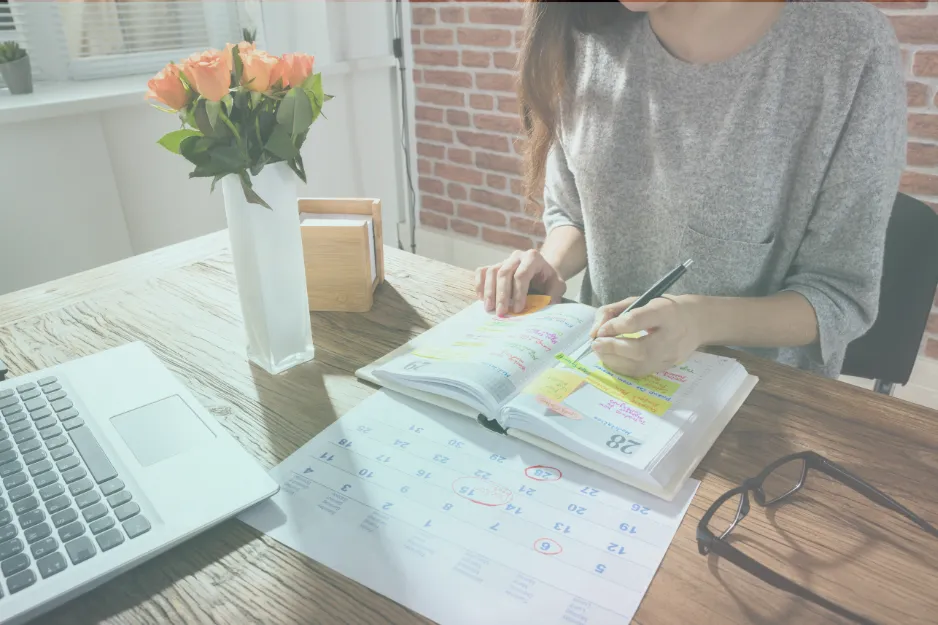 Woman planning her signature coaching offer at her workspace