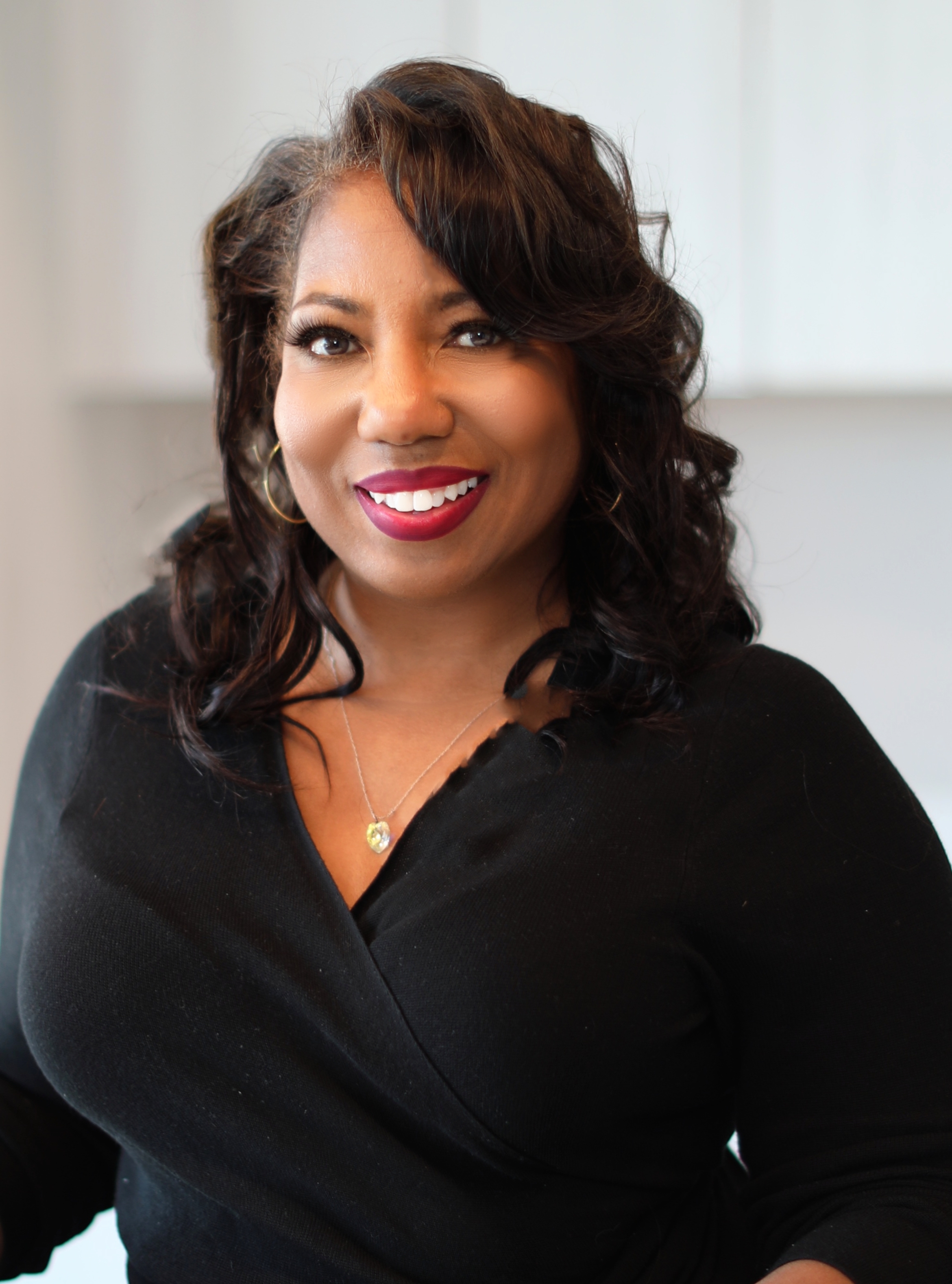 Calm, confident woman entrepreneur working in a light, minimal studio