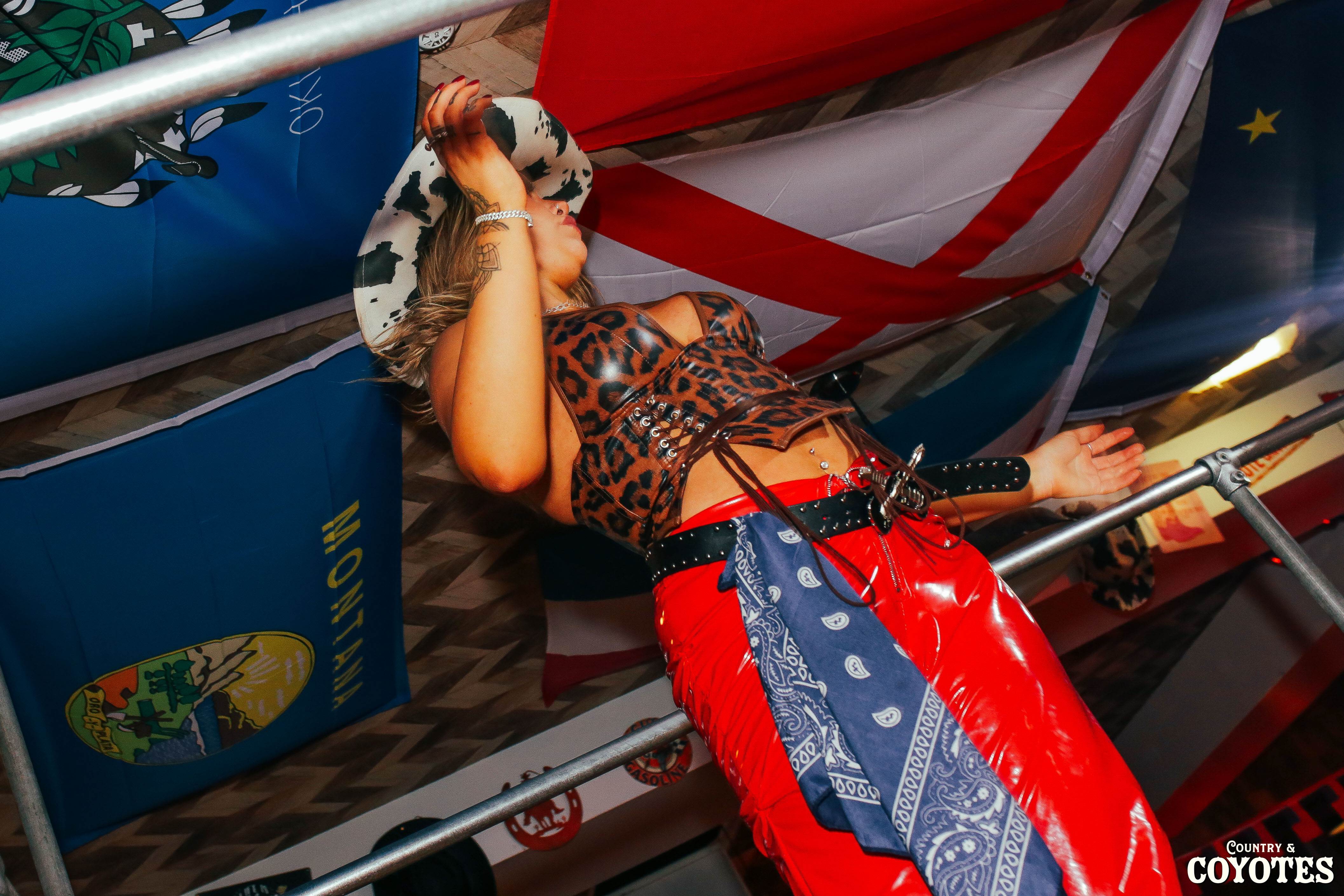 Motion-blurred action shot of Cowgirls dancing on the bars in a neon lit country bar