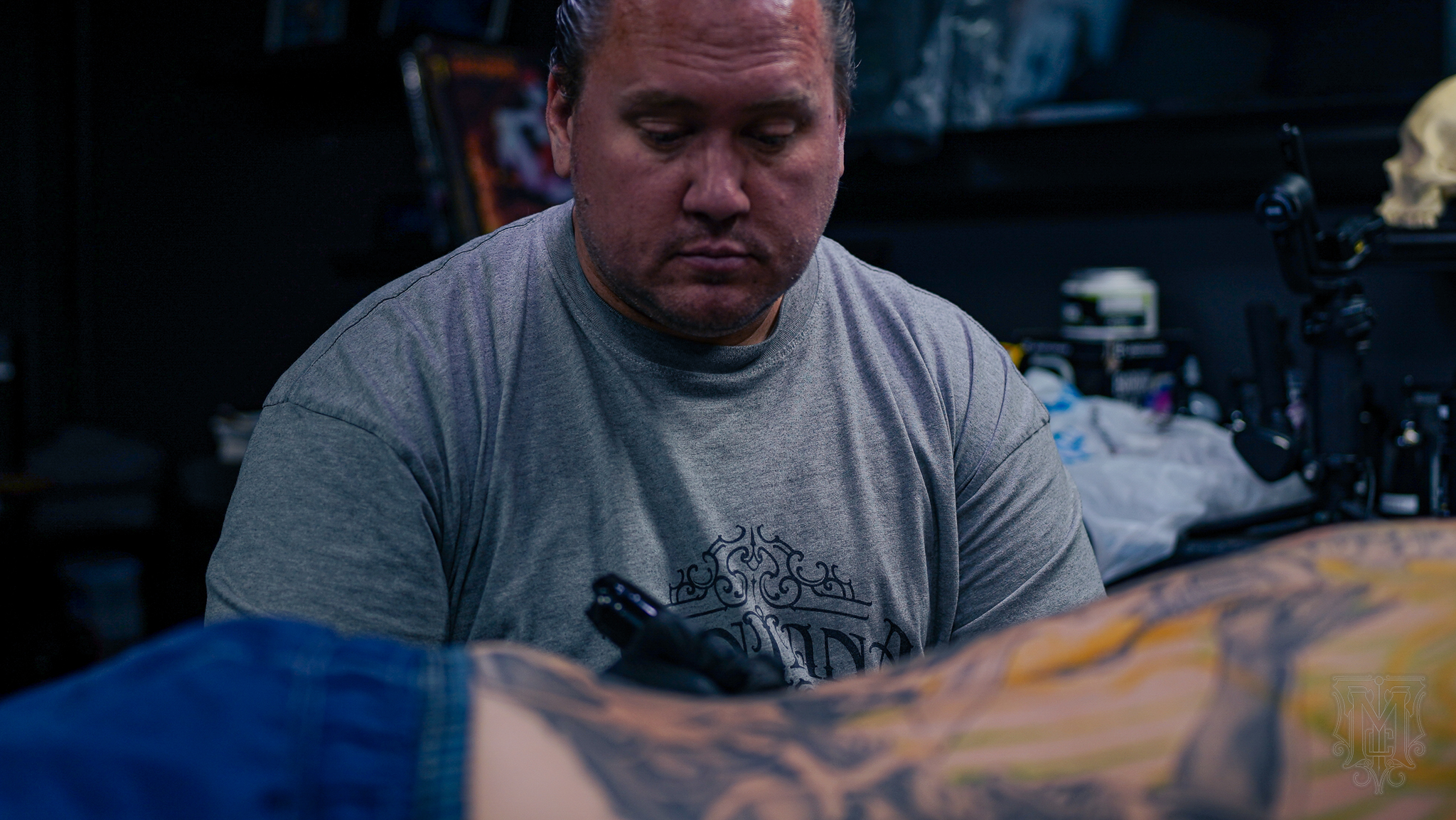 Tattoo artist working in studio