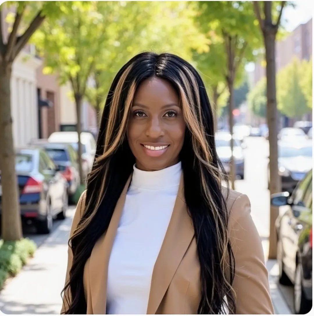 A confident founder with a warm smile, standing in a sunlit office filled with books and plants, exuding approachability and expertise. The portrait captures a sense of purpose and dedication to organizational growth.