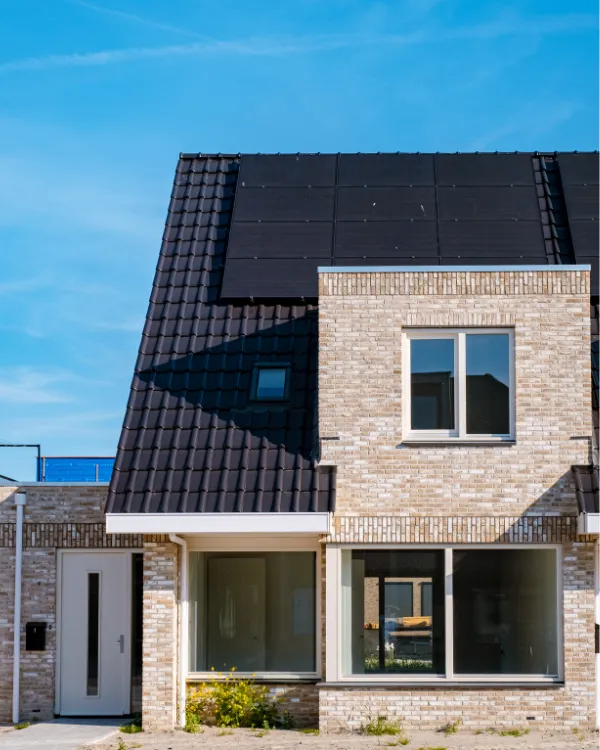 A brick home with soalr panels installed.