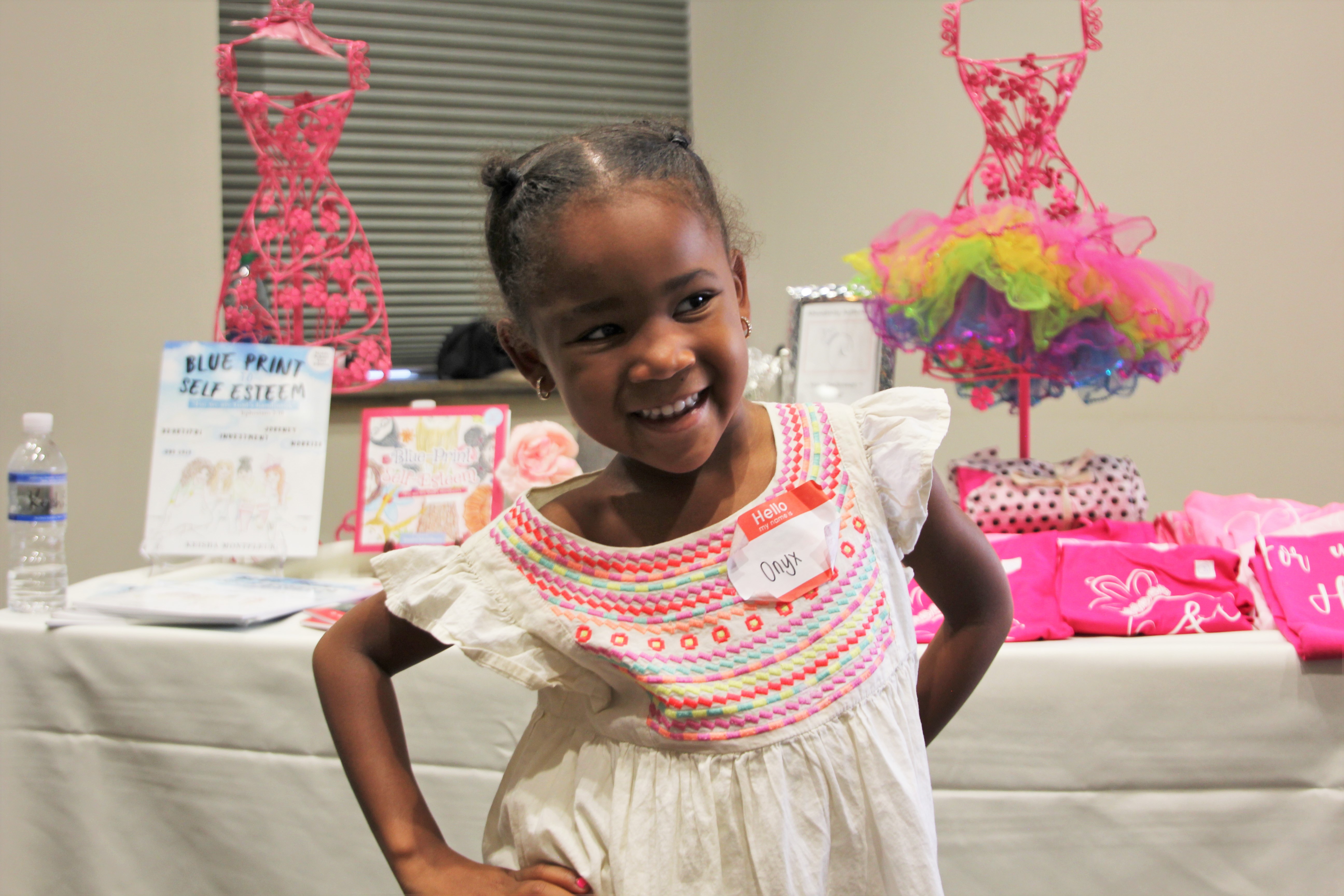 Child waves at laptop