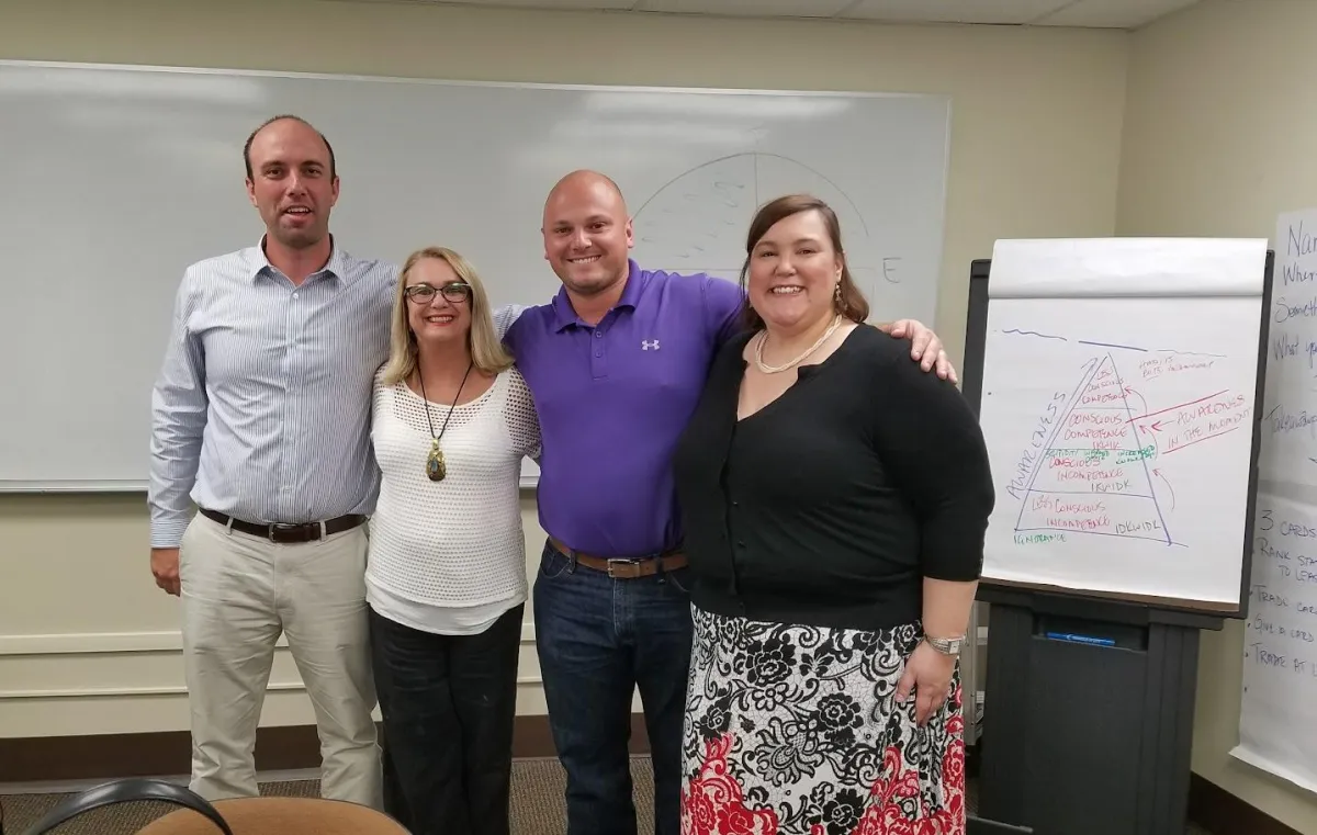 Melinda Stallings standing with a team posing for camera after a successful training