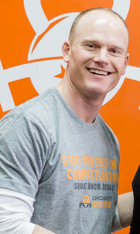 CrossFit Solid Orange head coach working with athlete