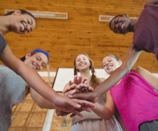 Kids in a circle with hands together