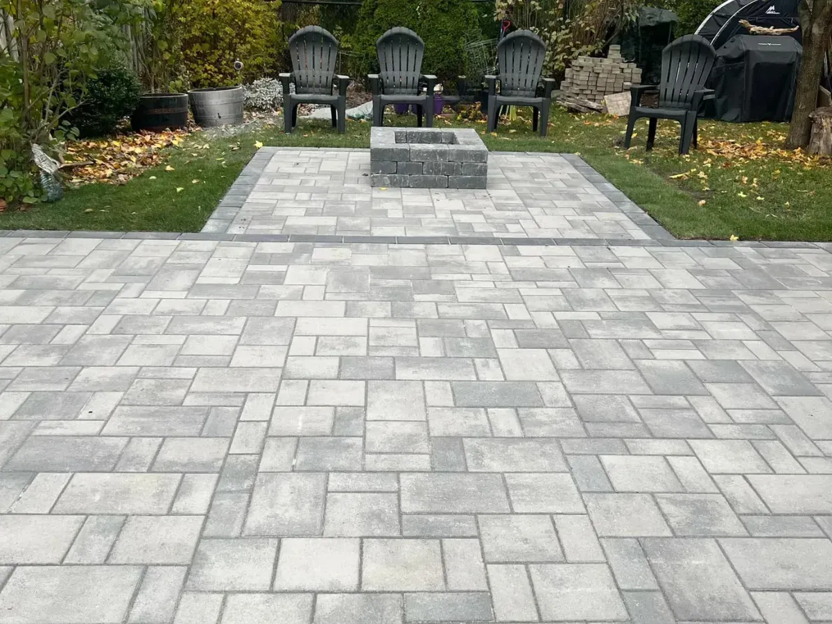 Custom stone patio with custom firepit designed for outdoor living and relaxation by Big G Landscapes in Barrie.