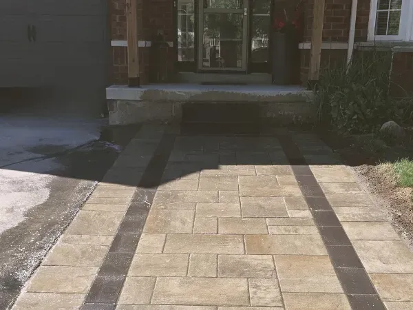 Modern custom stone front entrance and interlocking walkway renovation completed by Big G Landscapes in Barrie, ON