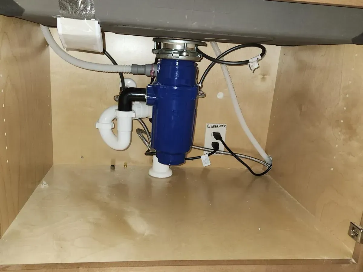 Ceiling plumbing repair showing exposed PVC drain pipe and cut-out drywall — professional leak inspection and pipe repair by Lion Plumbing.