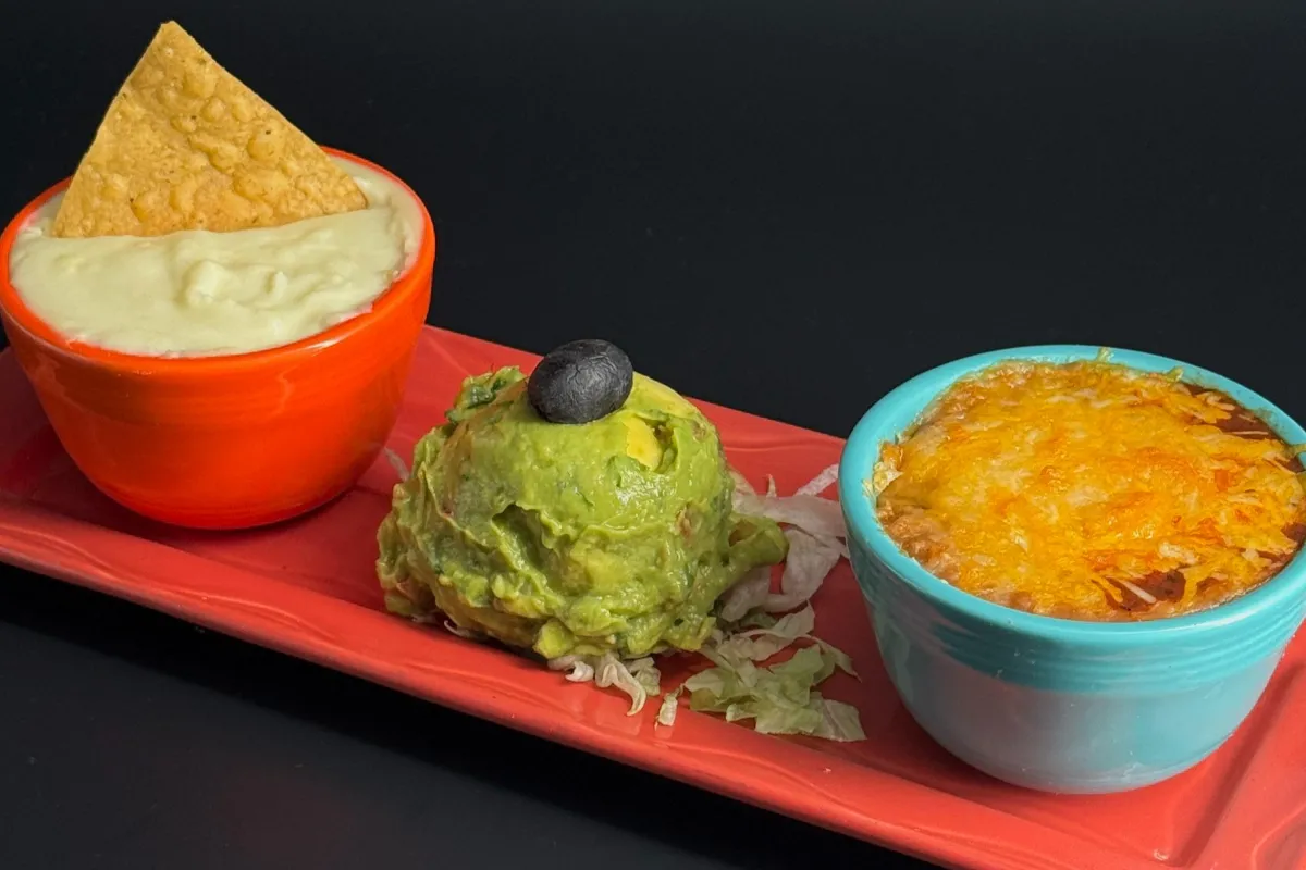 Mexican Trio: Our dipping trio consists of fresh guacamole, jalapeño cheese sauce, and a Mexican bean dip made with salsa Quemada and melted cheese.