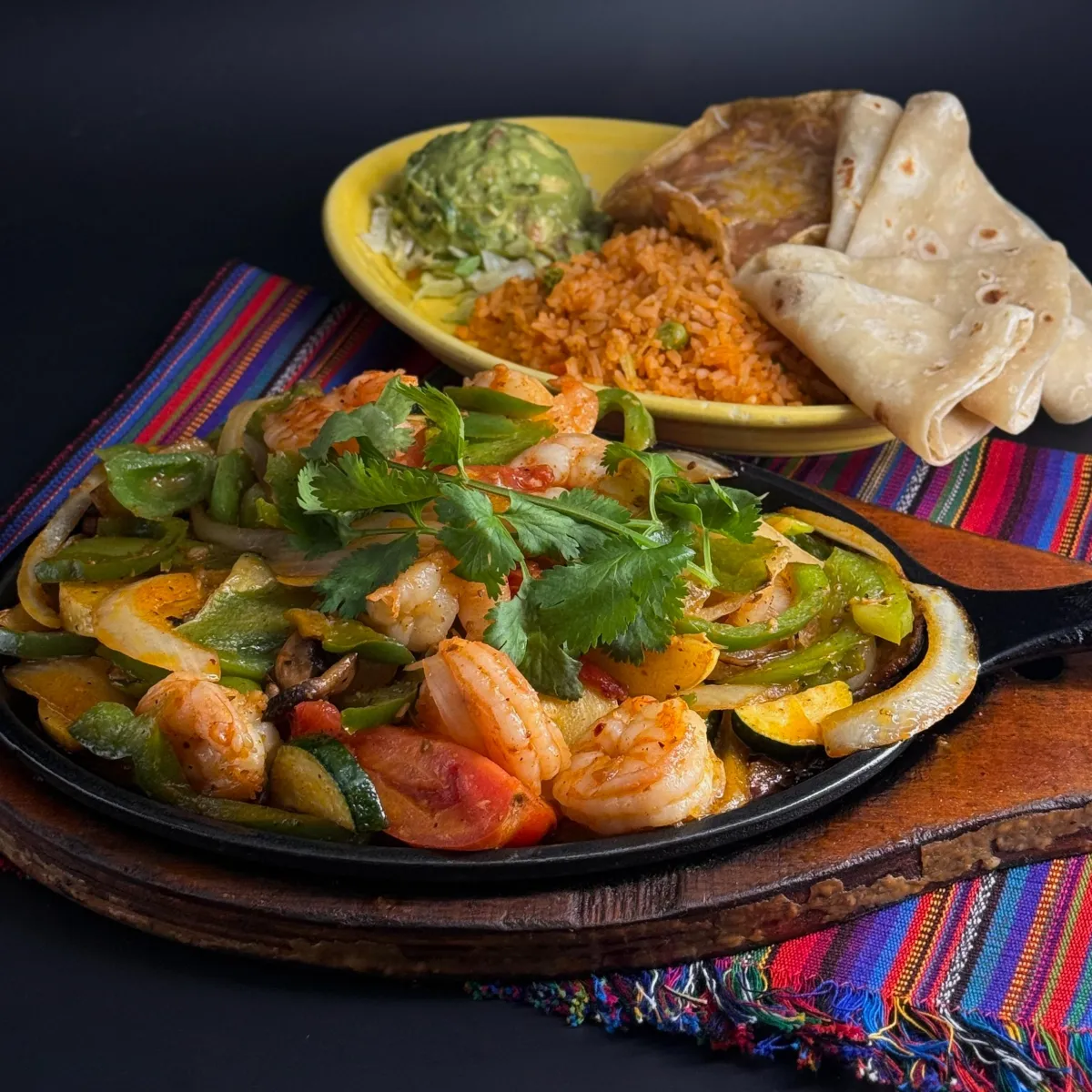 Shrimp Fajitas Pacific wild salmon grilled to perfection, served over a vibrant salad of fresh romaine, juicy grapes, tangy oranges, and creamy avocado. All dressed with a zesty chipotle mango dressing for a sweet and smoky finish. A refreshing and hearty choice.