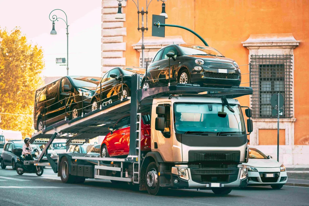 tow truck with 5 cars on its flatbed on a long distance tow job