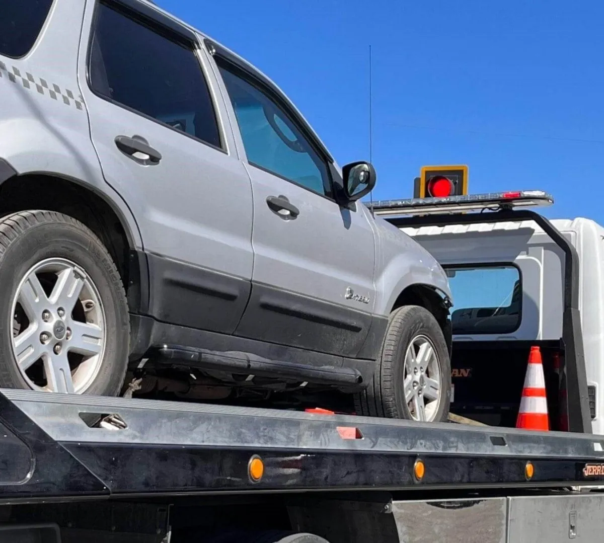 SUV in the back of a flatbed of a tow truck