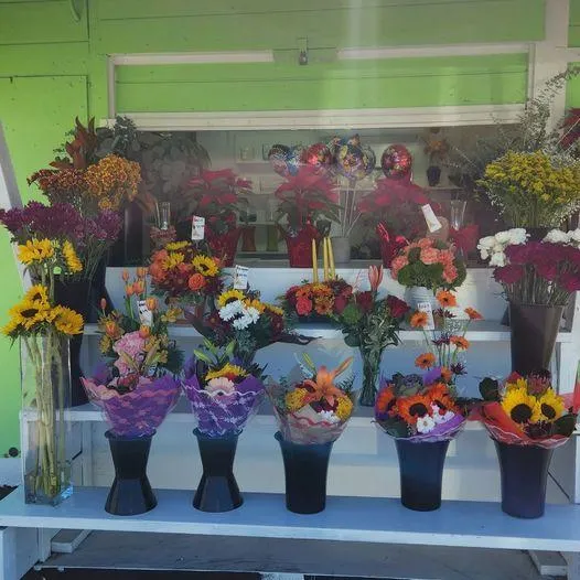 over a dozen bouquets of flowers of all colors on display