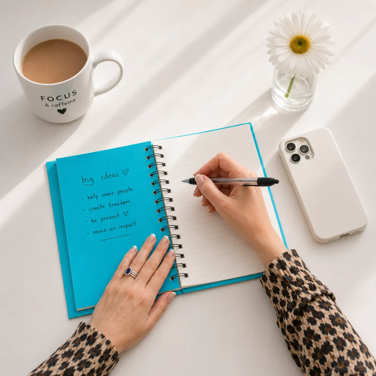 Woman looking thoughtfully at a notebook