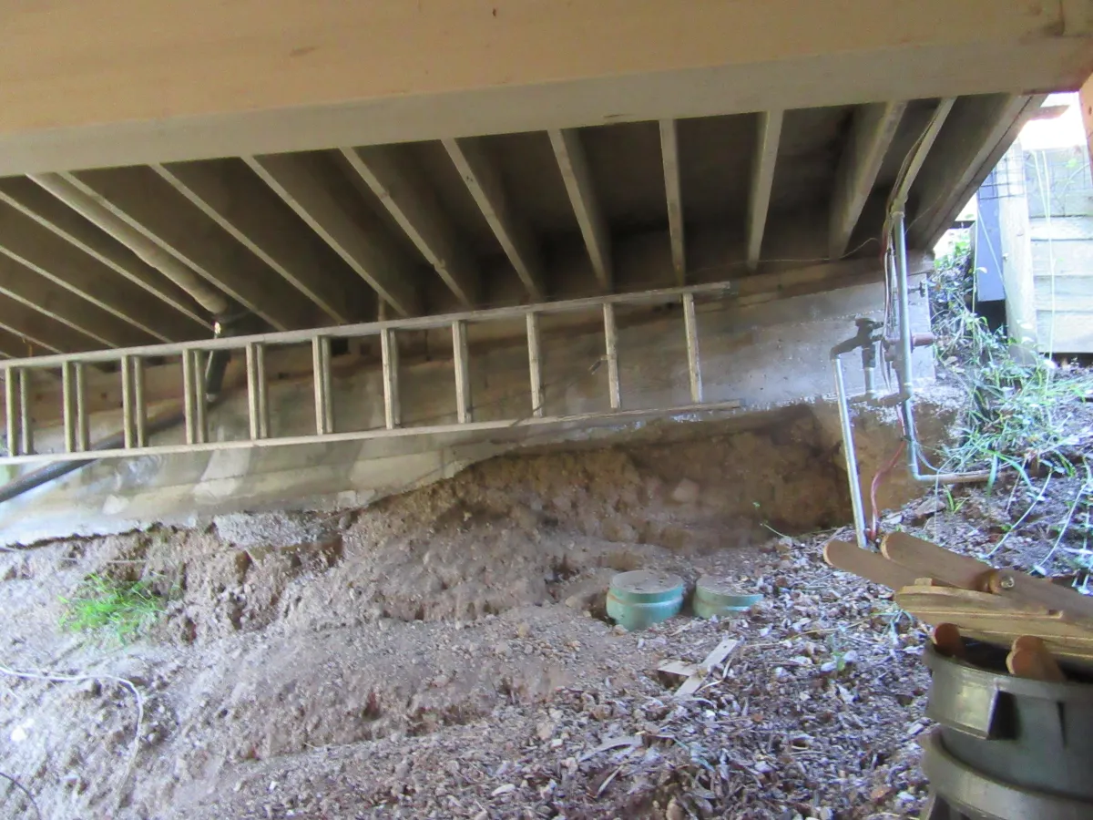 Foundation undermining of driveway bridge due to soil erosion and drainage issue