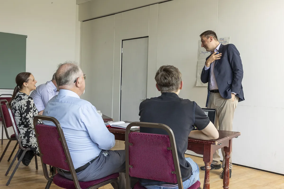 Nick Whitehouse leading a trauma-informed training session at a flipchart