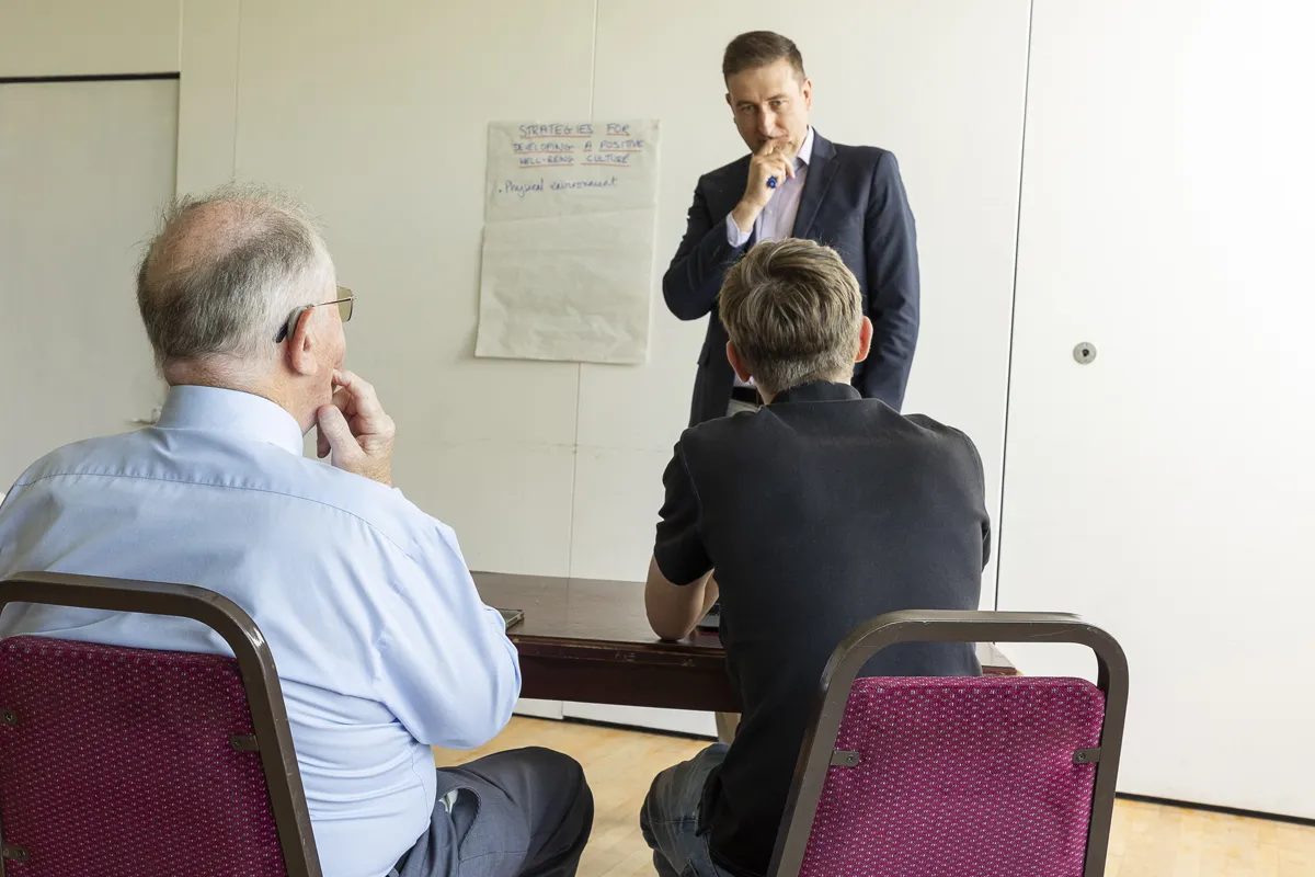 Nick Whitehouse leading a trauma-informed training session at a flipchart