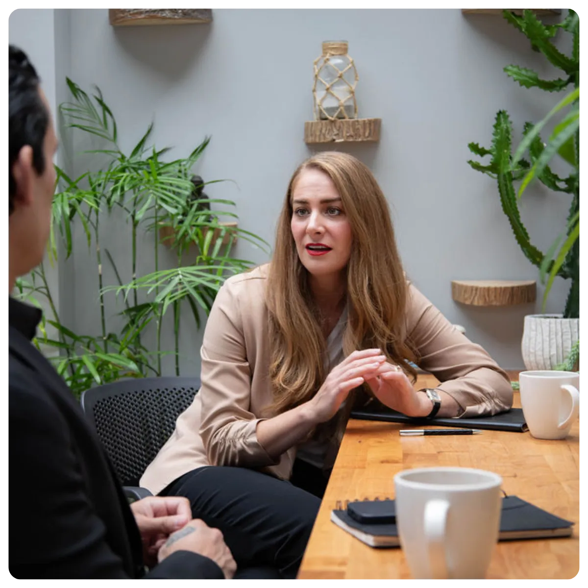 A male leader overseeing the work of a female employee