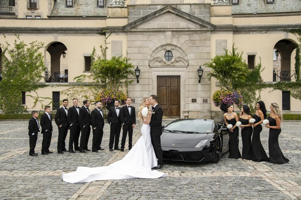 Oheka Castle wedding photographer bride groom and bridal party in front of castle Long Island NY by Lotus Wedding Photography